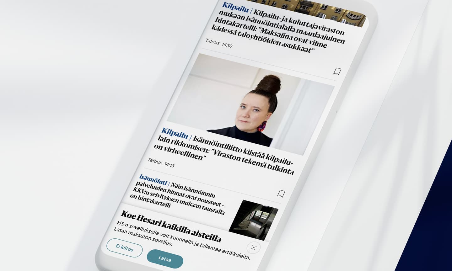 Finnish news website on a mobile phone showing articles about consumer protection and housing regulations.