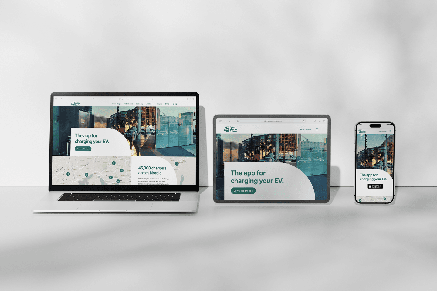 Charge & Drive EV charging app displayed on laptop, tablet and smartphone devices against a grey background.