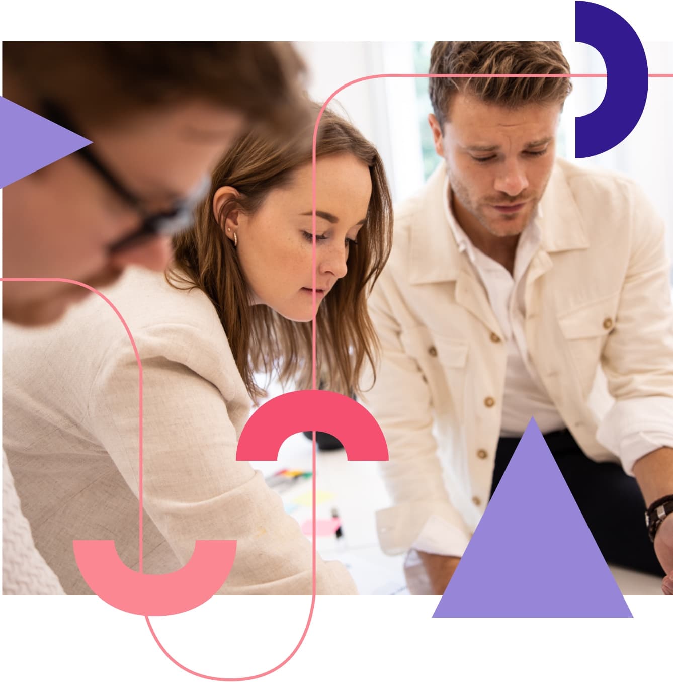 Three professionals in light-coloured attire examining documents, with pink and purple geometric shapes overlaid on the image.